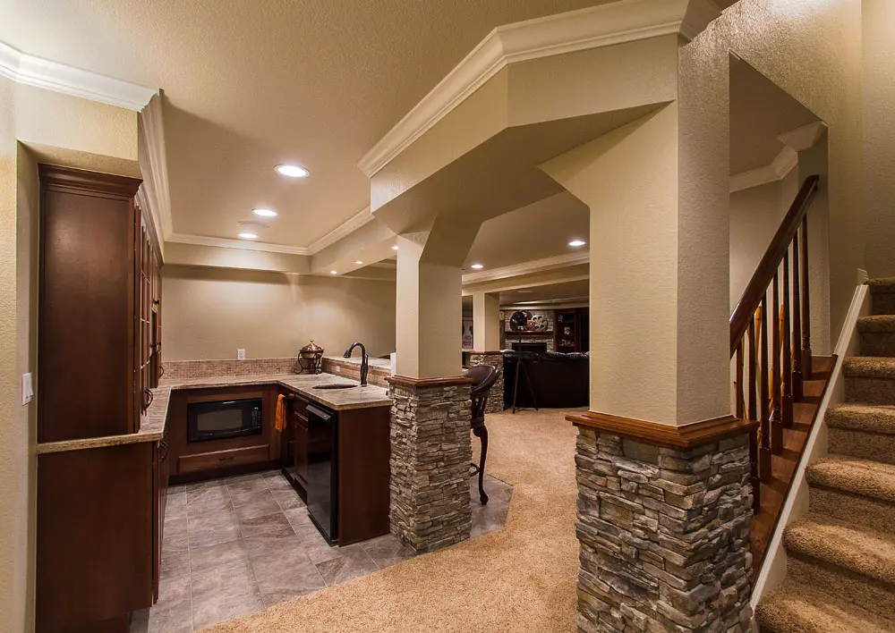 A kitchen with stone walls and floors