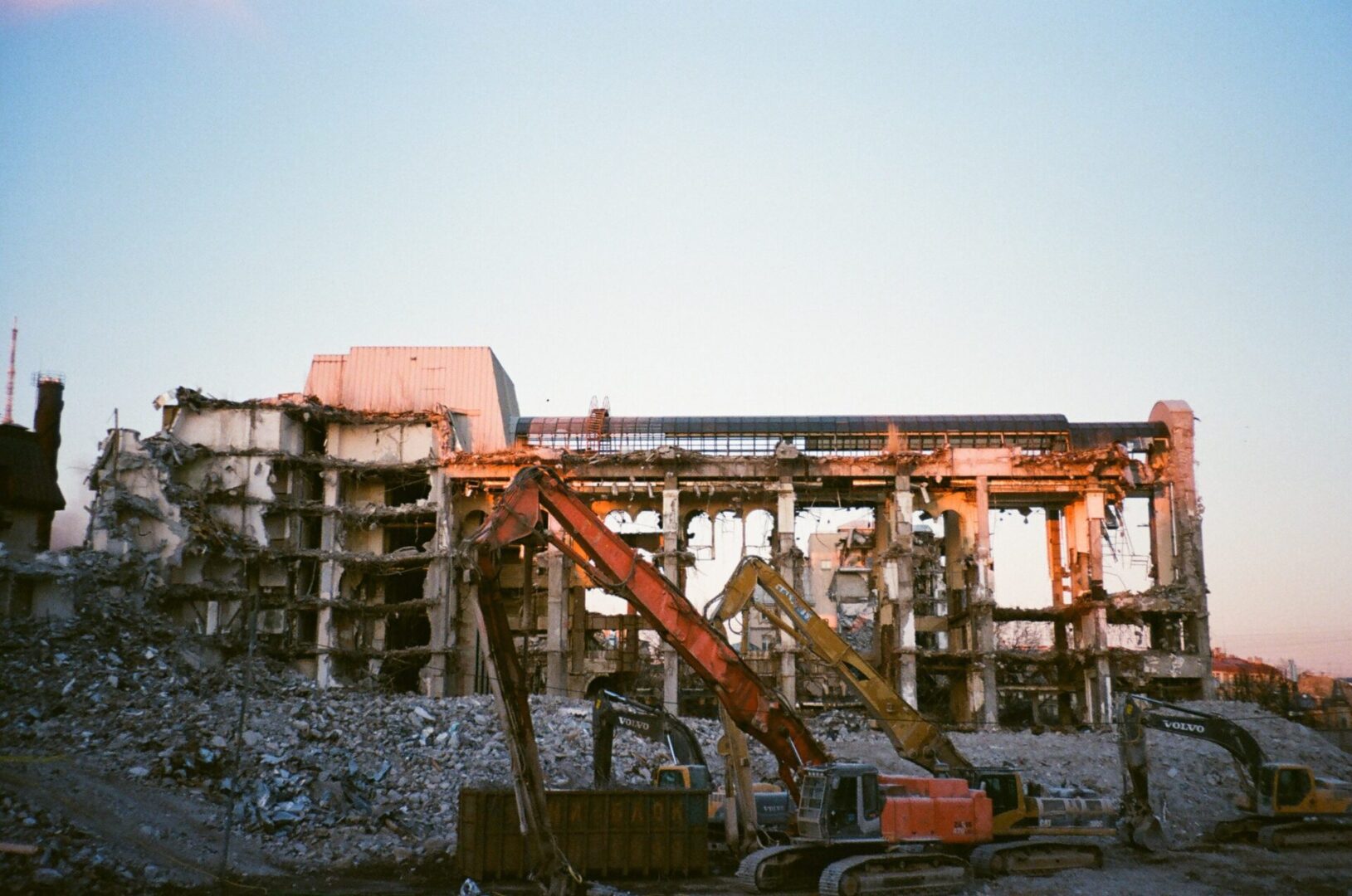 A construction site with cranes and rubble in the foreground.